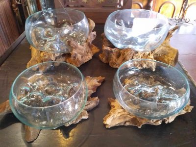 Tree stumps cradling blown glass bowls