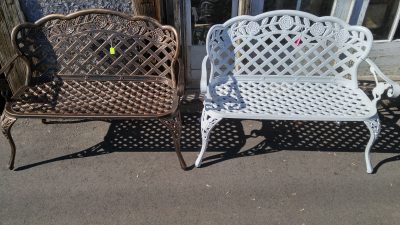 2 Cast Iron Outdoor Benches, 1 in a metallic black and brass colour, and the other painted white